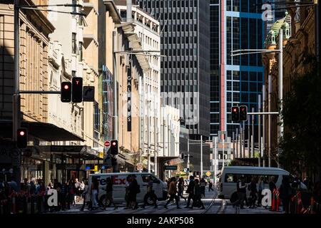 Sydney, Australia - October 02 2019: Pedestrians cross the street in the busy Sydney downtown district in Australia largest city Stock Photo