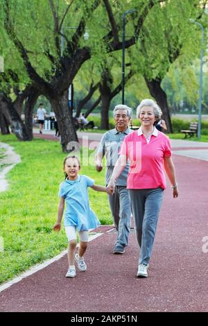 Older couples with a granddaughter in outside for a walk Stock Photo