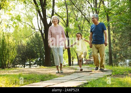 Older couples with a granddaughter picnic in the park Stock Photo