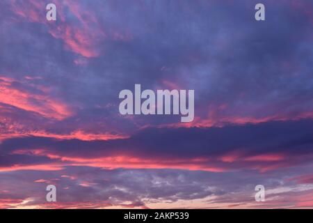 dramatic cloudy sky in the rays of setting sun. Stock Photo