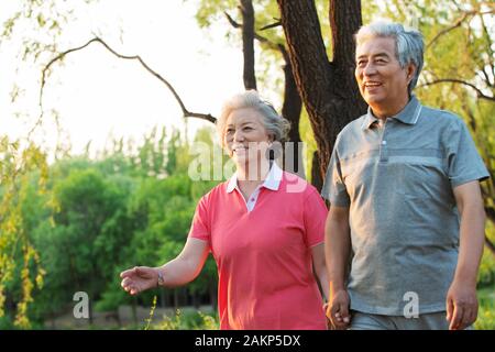 The happiness of the elderly couple walking in the park Stock Photo