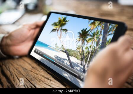 Cropped Image Of Man Watching Movie On Digital Tablet At Home Stock Photo