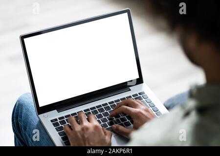 Close-up Of Young Man Working On Laptop At Home Stock Photo