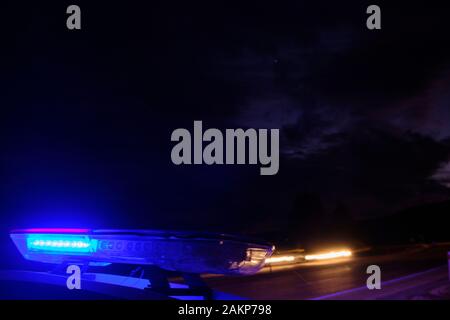 police car flashing lights in the night selective focus. Stock Photo