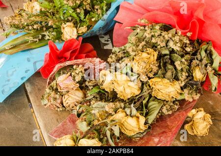 Bouquet of dried roses  on old table Stock Photo