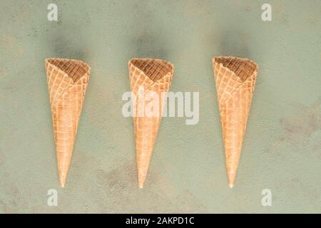 three empty ice cream cones on table Stock Photo