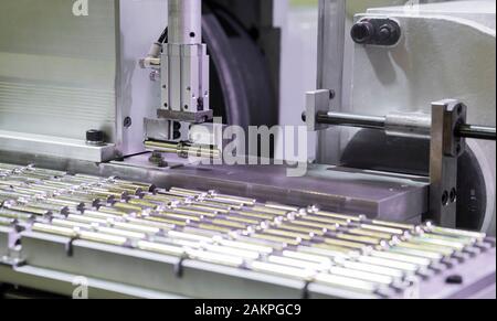 Robot  arm pick small machined parts to next manufacturing process , machining ; industrial engineering equipement process background Stock Photo