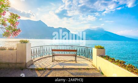 Bench on lakefront in Como Lake landscape at sunset. Bellagio Italy Europe Stock Photo