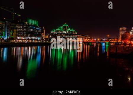 Dublin city  at Night, lights reflecting off the River Liffey.Office buildings in Dublin financial district at night. Stock Photo