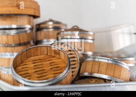 Stack of bamboo steamers in a kitchen in China Stock Photo