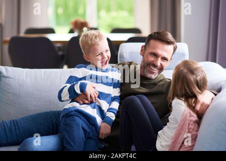 Happy dad and his children spending time together Stock Photo