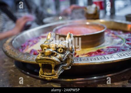 Chengdu Sichuan Hot Pot close up with dragon head sculpted handles, Chenggdu, Sichuan Province, China Stock Photo