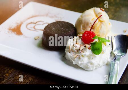 vanilla ice cream and brownie on white plate Stock Photo