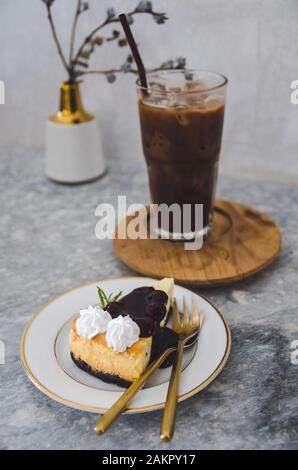 burberry cheese cake and iced cocoa glass focus on cake Stock Photo