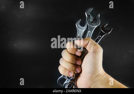 hand hold wrench on blackground Stock Photo