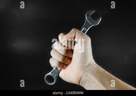 hand hold wrench on blackground Stock Photo