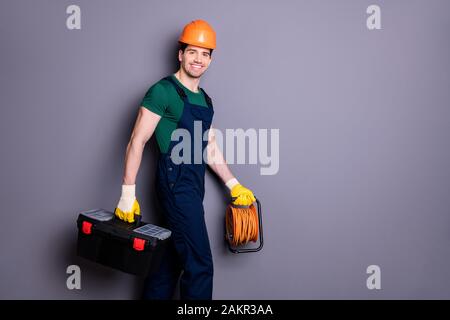 Profile side view portrait of his he nice attractive cheerful professional qualified workman walking renovation service carrying instruments isolated Stock Photo