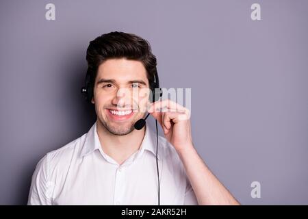 Portrait of smart confident call center worker man wear earphones can help customers clients wear formalwear clothing isolated over grey color