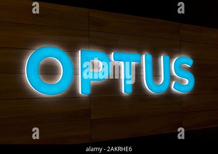 Brisbane, Queensland, Australia - 20th December 2019 : Illuminated Optus sign hanging in front of a store in Brisbane. Optus is the second largest tel Stock Photo