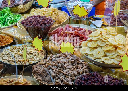 Multi-colored oriental spices, dried fruit and ginger on the counter of the oriental market Stock Photo