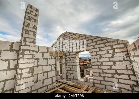 Building site of a house under construction made from white foam concrete blocks. Stock Photo
