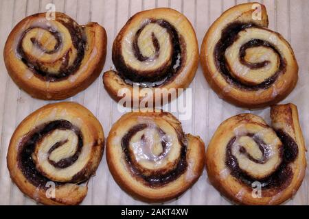 Freshly baked homemade cinnamon rolls or buns, close up overhead shot Stock Photo