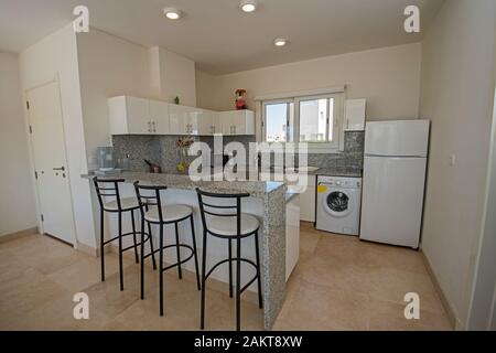 Kitchen in luxury villa show home showing interior design decor furnishing with breakfast bar Stock Photo
