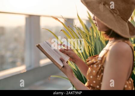 Portrait of young Asian girl is reading book in roof top of building. Stock Photo