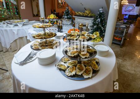 Fresh open oyster on a white plate. in the restaurant appetizer. Stock Photo