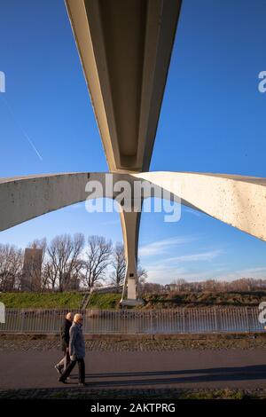 pedestrians under the bridge in the Rhine harbor in the district Muelheim, Cologne, Germany.  Fussgaenger unter der Katzenbuckelbruecke im Muelheimer Stock Photo