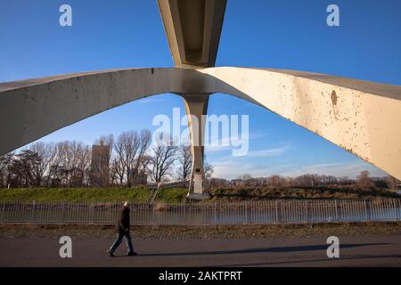pedestrian under the bridge in the Rhine harbor in the district Muelheim, Cologne, Germany.  Fussgaenger unter der Katzenbuckelbruecke im Muelheimer H Stock Photo