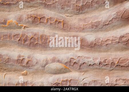 Full frame abstract background of crusty textured red sandstone in wavy layers Stock Photo