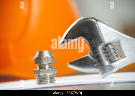 Plumbing pipeline element and adjustable wrench Stock Photo