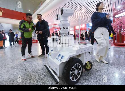 A police robot powered by the 5G wireless service of China Mobile patrols the East Hangzhou Railway Station during the annual Spring Festival travel r Stock Photo