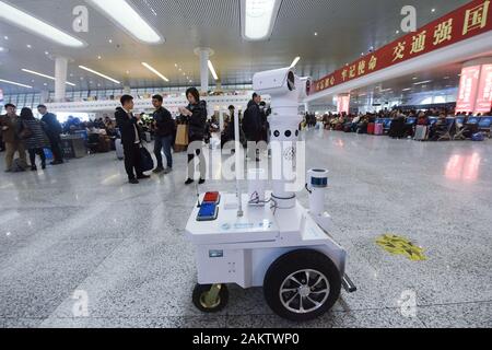 A police robot powered by the 5G wireless service of China Mobile patrols the East Hangzhou Railway Station during the annual Spring Festival travel r Stock Photo