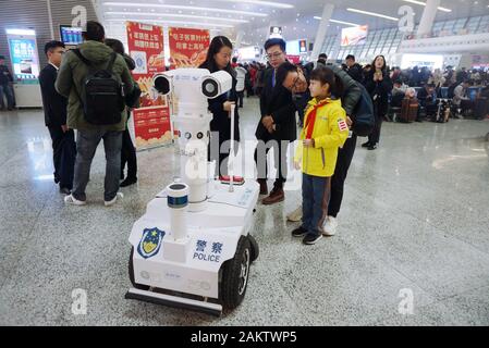 A police robot powered by the 5G wireless service of China Mobile patrols the East Hangzhou Railway Station during the annual Spring Festival travel r Stock Photo