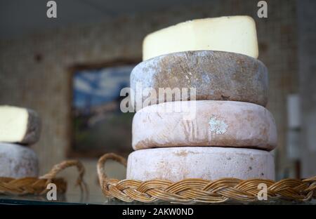 Delicious artisan Pyrenean cheese on sale at the indoor market of Nay, Pyrenees Atlantiques, Nouvelle Aquitaine, France Stock Photo