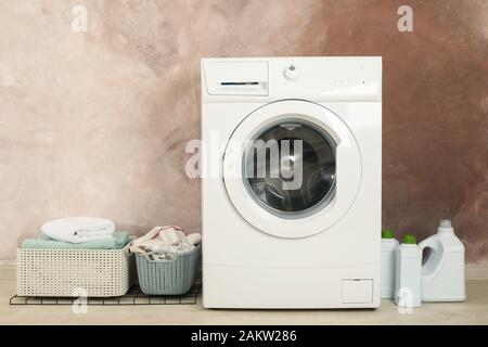 Laundry room with washing machine against brown wall Stock Photo