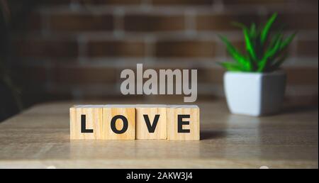 Love message written in wooden blocks. brick background Stock Photo