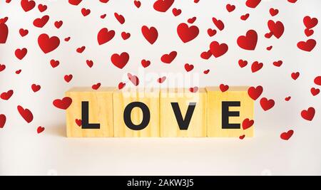 Love message written in wooden blocks. Red heart. Stock Photo