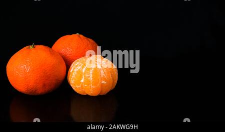 Tangerines isolated on black background. Copy space. Stock Photo
