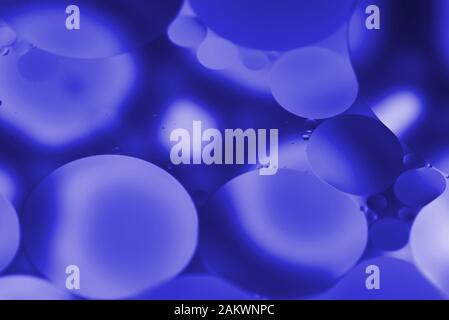 Artistic close-up of floating translucent blue bubbles in liquid, creating a modern abstract background Stock Photo
