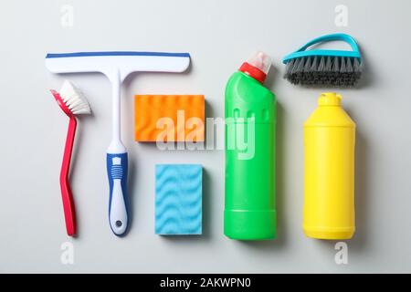 Flat lay with detergents and cleaning supplies on grey background, top view Stock Photo