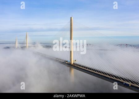 South Queensferry, Scotland, UK. 10th Jan 2020. Drone image of a spectacular cloud inversion at Queensferry Crossing Bridge with the lower half of the bridge shrouded in fog but the upper half in beautiful sunny weather. In background the Forth Bridge and Forth Road Bridge. Iain Masterton/Alamy Live News