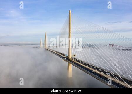 South Queensferry, Scotland, UK. 10th Jan 2020. Drone image of a spectacular cloud inversion at Queensferry Crossing Bridge with the lower half of the bridge shrouded in fog but the upper half in beautiful sunny weather. In background the Forth Bridge and Forth Road Bridge. Iain Masterton/Alamy Live News Stock Photo