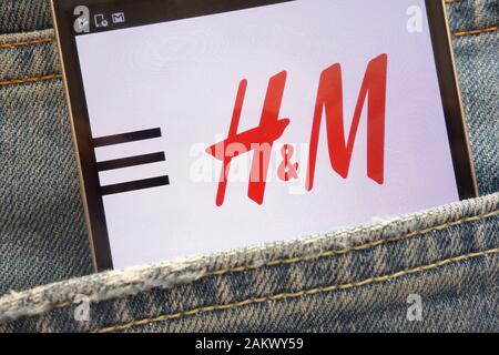 H&M website displayed on smartphone hidden in jeans pocket Stock Photo