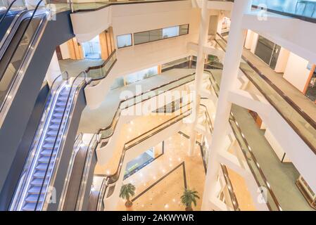 Aerial view interior of modern building with stack of escalator in Singapore Stock Photo