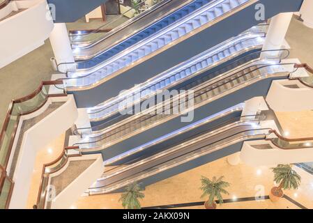 Modern escalator stack on top of each other insider a commercial building in Singapore Stock Photo
