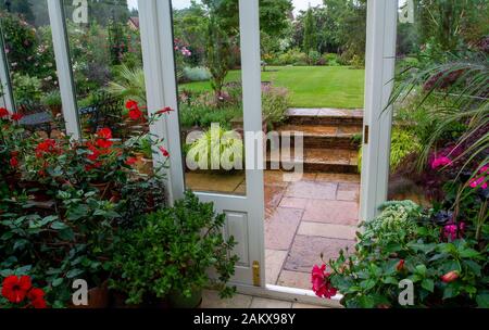 Three flagstone steps in a beautifully designed garden Stock Photo