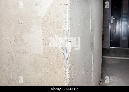 Damaged corners of plastered walls, visible aluminum corner. Stock Photo